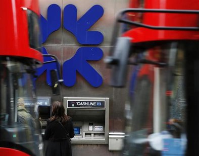 People stand near a branch of Royal Bank of Scotland (RBS) in London November 1, 2013. REUTERS/Luke MacGregor People stand near a branch of Royal Bank of Scotland (RBS) in London November 1, 2013. REUTERS/Luke MacGregor