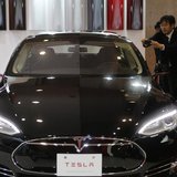 People take pictures of a Tesla Model S car, displayed at the 43rd Tokyo Motor Show November 20, 2013. REUTERS/Yuya Shino People take pictures of a Tesla Model S car, displayed at the 43rd Tokyo Motor Show November 20, 2013. REUTERS/Yuya Shino