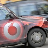 Vodafone branding is seen on the side of a London taxi in London November 12, 2013. REUTERS/Toby Melville Vodafone branding is seen on the side of a London taxi in London November 12, 2013. REUTERS/Toby Melville