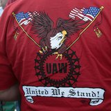 A United Auto Workers union member wears a shirt with 'UAW United We Stand' on it during a ceremony where members of UAW Local 600 unfurled A United Auto Workers union member wears a shirt with 'UAW United We Stand' on it during a ceremony where members of UAW Local 600 unfurled