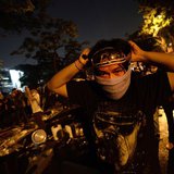 Anti-government protesters take cover from tear gas as they attack Government House during demonstrations in Bangkok December 2, 2013. REUTE Anti-government protesters take cover from tear gas as they attack Government House during demonstrations in Bangkok December 2, 2013. REUTE