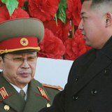 North Korean leader Kim Jong-un (R), walks past his uncle North Korean politician Jang Song-thaek, during a military parade to mark the birt North Korean leader Kim Jong-un (R), walks past his uncle North Korean politician Jang Song-thaek, during a military parade to mark the birt
