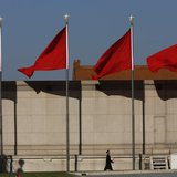 A Paramilitary soldier walks underneath red flags on the Tiananmen square next to the Great Hall of the People where the Chinese Communist P A Paramilitary soldier walks underneath red flags on the Tiananmen square next to the Great Hall of the People where the Chinese Communist P