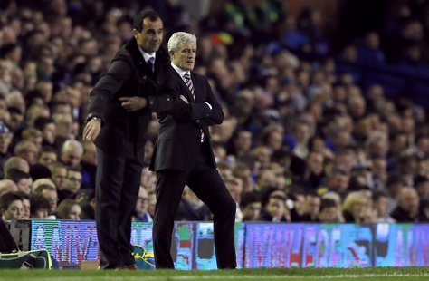 Everton's manager Roberto Martinez (L) gestures as his Stoke City counterpart Mark Hughes looks on during their English Premier League socce Everton's manager Roberto Martinez (L) gestures as his Stoke City counterpart Mark Hughes looks on during their English Premier League socce