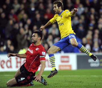 Arsenal's Mathieu Flamini (R) scores a goal against Cardiff City during their English Premier League soccer match at Cardiff City Stadium in Arsenal's Mathieu Flamini (R) scores a goal against Cardiff City during their English Premier League soccer match at Cardiff City Stadium in