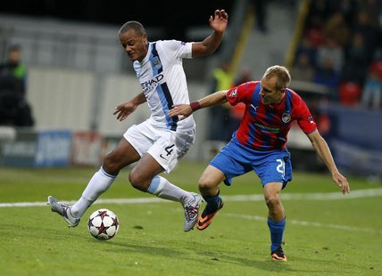 Manchester City's Vincent Kompany (L) challenges Viktoria Plzen's Daniel Kolar during their Champions League group D soccer match at the Doo Manchester City's Vincent Kompany (L) challenges Viktoria Plzen's Daniel Kolar during their Champions League group D soccer match at the Doo