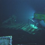 Hawaii Undersea Research Laboratory (HURL) photo shows a light from a research submarine illuminating the deck of a submerged World War II-e Hawaii Undersea Research Laboratory (HURL) photo shows a light from a research submarine illuminating the deck of a submerged World War II-e