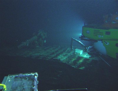 Hawaii Undersea Research Laboratory (HURL) photo shows a light from a research submarine illuminating the deck of a submerged World War II-e Hawaii Undersea Research Laboratory (HURL) photo shows a light from a research submarine illuminating the deck of a submerged World War II-e