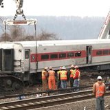 Heavy cranes lift a derailed Metro-North train car back onto the tracks in New York, in this still image from video taken by the National Tr Heavy cranes lift a derailed Metro-North train car back onto the tracks in New York, in this still image from video taken by the National Tr