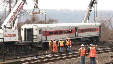 Heavy cranes lift a derailed Metro-North train car back onto the tracks in New York, in this still image from video taken by the National Tr Heavy cranes lift a derailed Metro-North train car back onto the tracks in New York, in this still image from video taken by the National Tr