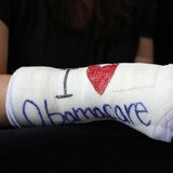 Cathey Park of Cambridge, Massachusetts wears a cast for her broken wrist with "I Love Obamacare" written upon it prior to U.S. President Ba Cathey Park of Cambridge, Massachusetts wears a cast for her broken wrist with "I Love Obamacare" written upon it prior to U.S. President Ba