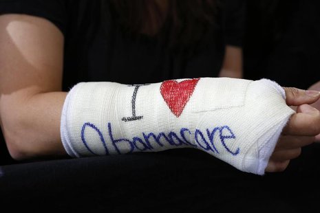 Cathey Park of Cambridge, Massachusetts wears a cast for her broken wrist with "I Love Obamacare" written upon it prior to U.S. President Ba Cathey Park of Cambridge, Massachusetts wears a cast for her broken wrist with "I Love Obamacare" written upon it prior to U.S. President Ba