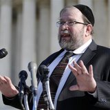 Rabbi Binyomin Ginsberg talks to reporters about his case, in which he sued Northwest Airlines for breach of contract after the airline said Rabbi Binyomin Ginsberg talks to reporters about his case, in which he sued Northwest Airlines for breach of contract after the airline said