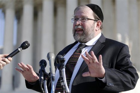 Rabbi Binyomin Ginsberg talks to reporters about his case, in which he sued Northwest Airlines for breach of contract after the airline said Rabbi Binyomin Ginsberg talks to reporters about his case, in which he sued Northwest Airlines for breach of contract after the airline said
