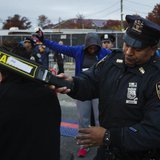 New York Police Department officers perform a security sweep on runners arriving to take part in the New York City Marathon, November 3, 201 New York Police Department officers perform a security sweep on runners arriving to take part in the New York City Marathon, November 3, 201