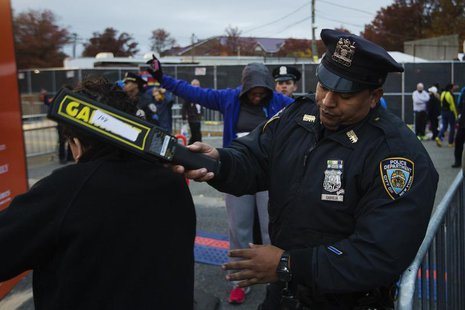 New York Police Department officers perform a security sweep on runners arriving to take part in the New York City Marathon, November 3, 201 New York Police Department officers perform a security sweep on runners arriving to take part in the New York City Marathon, November 3, 201