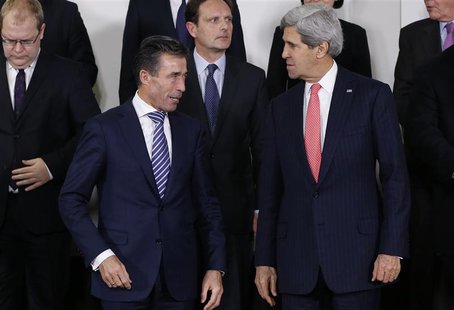 NATO Secretary General Anders Fogh Rasmussen and U.S. Secretary of State John Kerry (R) pose for a family photo during a NATO foreign minist NATO Secretary General Anders Fogh Rasmussen and U.S. Secretary of State John Kerry (R) pose for a family photo during a NATO foreign minist