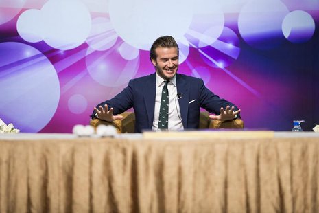 Former England soccer team captain David Beckham reacts during a promotional event at the Venetian Macao hotel in Macau November 22, 2013. R Former England soccer team captain David Beckham reacts during a promotional event at the Venetian Macao hotel in Macau November 22, 2013. R
