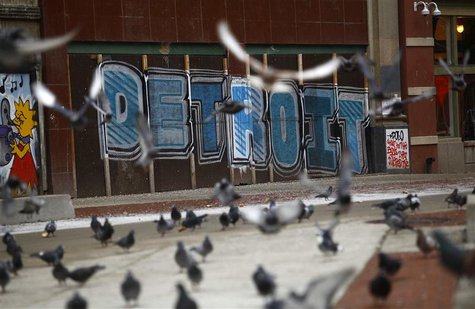 Pigeons are seen near graffiti in Detroit, Michigan, December 3, 2013. REUTERS/Joshua Lott Pigeons are seen near graffiti in Detroit, Michigan, December 3, 2013. REUTERS/Joshua Lott