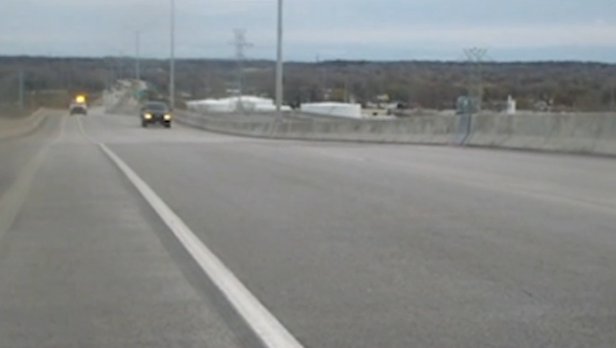 The first vehicle allowed across the bridge after stabilization was equipped with a "Snooper" to examine the bridge deck in early December. The asphalt was said to be in good shape. Courtesy of WisDOT.