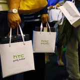 Customers hold bags containing their HTC One mobile phone purchases during the first day of public sales at Taman Anggrek Mall in Jakarta, J Customers hold bags containing their HTC One mobile phone purchases during the first day of public sales at Taman Anggrek Mall in Jakarta, J