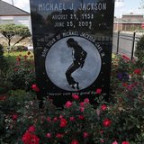 Two boys look through the fence surrounding the childhood home of singer Michael Jackson in Gary, Indiana, October 23, 2013. REUTERS/Jim You Two boys look through the fence surrounding the childhood home of singer Michael Jackson in Gary, Indiana, October 23, 2013. REUTERS/Jim You