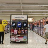 A customer service representative stands in an aisle at a Tesco Extra supermarket in Watford, north of London August 8, 2013. REUTERS/Suzann A customer service representative stands in an aisle at a Tesco Extra supermarket in Watford, north of London August 8, 2013. REUTERS/Suzann
