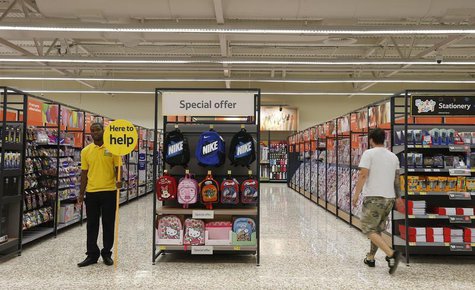A customer service representative stands in an aisle at a Tesco Extra supermarket in Watford, north of London August 8, 2013. REUTERS/Suzann A customer service representative stands in an aisle at a Tesco Extra supermarket in Watford, north of London August 8, 2013. REUTERS/Suzann