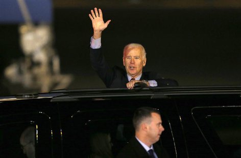 U.S. Vice President Joseph Biden waves from his van upon his arrival at Haneda airport in Tokyo December 2, 2013. REUTERS/Issei Kato U.S. Vice President Joseph Biden waves from his van upon his arrival at Haneda airport in Tokyo December 2, 2013. REUTERS/Issei Kato