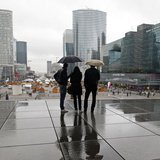 People are silhouetted as they shelter from rain under the Arche de la Defense, in the financial district west of Paris, November 8, 2013. R People are silhouetted as they shelter from rain under the Arche de la Defense, in the financial district west of Paris, November 8, 2013. R