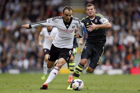 Fulham's Dimitar Berbatov (L) challenges Stoke City's Erik Pieters during their English Premier League soccer match at Craven Cottage in Lon Fulham's Dimitar Berbatov (L) challenges Stoke City's Erik Pieters during their English Premier League soccer match at Craven Cottage in Lon
