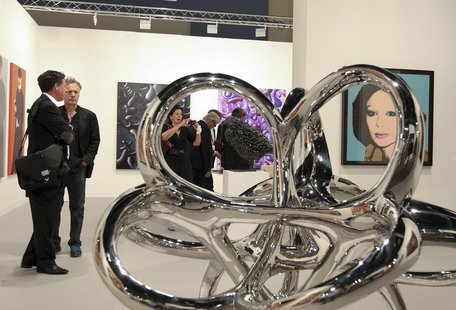 Art patrons are framed by World As Flow by Saint Clair Cemin at Art Basel in Miami Beach, Florida December 5, 2012. REUTERS/Robert Sullivan Art patrons are framed by World As Flow by Saint Clair Cemin at Art Basel in Miami Beach, Florida December 5, 2012. REUTERS/Robert Sullivan