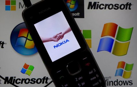 A Nokia mobile phone lies on a tablet computer showing logos of Microsoft, in this illustration picture taken in Frankfurt, November 18, 201 A Nokia mobile phone lies on a tablet computer showing logos of Microsoft, in this illustration picture taken in Frankfurt, November 18, 201