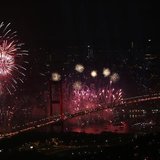 The Bosphorus Bridge that links the city's European and Asian sides, with the European side in the background, lights up with a fireworks di The Bosphorus Bridge that links the city's European and Asian sides, with the European side in the background, lights up with a fireworks di