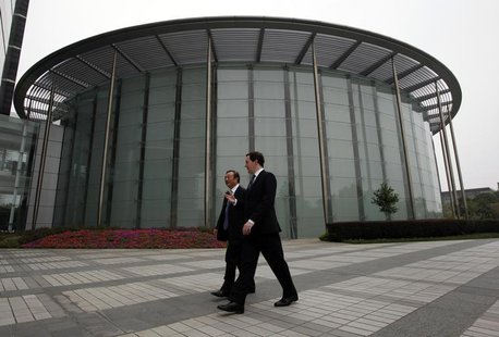 Britain's Chancellor of the Exchequer George Osborne (R) and Huawei Chief Executive and founder Ren Zhengfei talk at a campus at Huawei head Britain's Chancellor of the Exchequer George Osborne (R) and Huawei Chief Executive and founder Ren Zhengfei talk at a campus at Huawei head