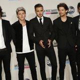 One Direction poses backstage with one of the two awards they won at the 41st American Music Awards in Los Angeles, California November 24, One Direction poses backstage with one of the two awards they won at the 41st American Music Awards in Los Angeles, California November 24,