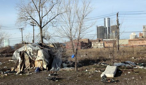 A makeshift homeless persons structure is seen, with General Motors Corp. world headquarters headquarters in the background, from an mostly A makeshift homeless persons structure is seen, with General Motors Corp. world headquarters headquarters in the background, from an mostly