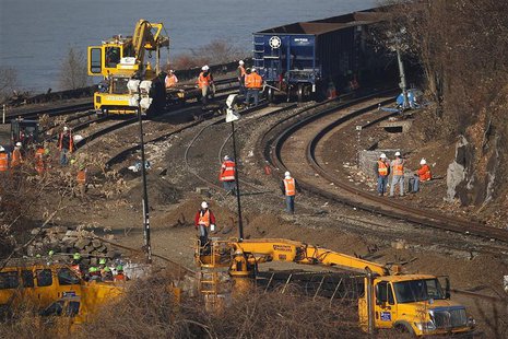 Workers are seen on the tracks of the Metro-North train derailment in the Bronx borough of New York December 3, 2013. REUTERS/Shannon Staple Workers are seen on the tracks of the Metro-North train derailment in the Bronx borough of New York December 3, 2013. REUTERS/Shannon Staple