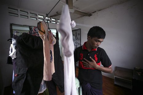 Bozor Mohammed from the Rakhine state in Myanmar puts his clothes, which were hung out to dry, inside his house after an interview with Reut Bozor Mohammed from the Rakhine state in Myanmar puts his clothes, which were hung out to dry, inside his house after an interview with Reut