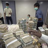 Employees count and pack money inside a bank in Yangon November 14, 2013. REUTERS/Minzayar Employees count and pack money inside a bank in Yangon November 14, 2013. REUTERS/Minzayar