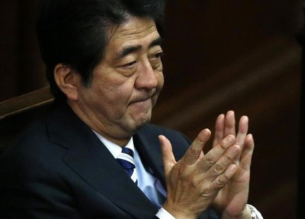 Japan's Prime Minister Shinzo Abe claps his hands during the Lower House plenary session of the parliament in Tokyo November 26, 2013. REUTE Japan's Prime Minister Shinzo Abe claps his hands during the Lower House plenary session of the parliament in Tokyo November 26, 2013. REUTE