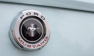 A Mustang badge is seen on Gail Wise's Skylight Blue 1964 1/2 Ford Mustang in Park Ridge, Illinois November 26, 2013. REUTERS/John Gress A Mustang badge is seen on Gail Wise's Skylight Blue 1964 1/2 Ford Mustang in Park Ridge, Illinois November 26, 2013. REUTERS/John Gress