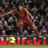 Liverpool's Luis Suarez takes a shot on goal against Norwich City during their English Premier League soccer match at Anfield in Liverpool, Liverpool's Luis Suarez takes a shot on goal against Norwich City during their English Premier League soccer match at Anfield in Liverpool,