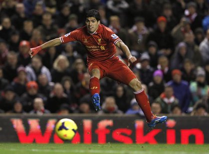 Liverpool's Luis Suarez takes a shot on goal against Norwich City during their English Premier League soccer match at Anfield in Liverpool, Liverpool's Luis Suarez takes a shot on goal against Norwich City during their English Premier League soccer match at Anfield in Liverpool,