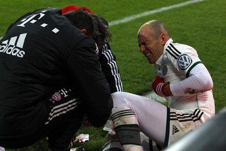 Bayern Munich's Arjen Robben reacts as medical assistants attend to his leg during the team's third round German soccer cup (DFB-Pokal) matc Bayern Munich's Arjen Robben reacts as medical assistants attend to his leg during the team's third round German soccer cup (DFB-Pokal) matc