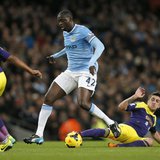 Manchester City's Yaya Toure (C) is challenged by Swansea's Pablo Hernandez during their English Premier League soccer match at the Etihad s Manchester City's Yaya Toure (C) is challenged by Swansea's Pablo Hernandez during their English Premier League soccer match at the Etihad s
