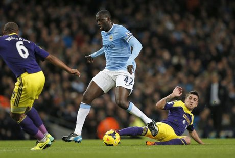 Manchester City's Yaya Toure (C) is challenged by Swansea's Pablo Hernandez during their English Premier League soccer match at the Etihad s Manchester City's Yaya Toure (C) is challenged by Swansea's Pablo Hernandez during their English Premier League soccer match at the Etihad s