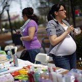 Karen Giral, 20, works at her booth selling Avon products at a Grameen America open house at St. John's University in New York April 18, 200 Karen Giral, 20, works at her booth selling Avon products at a Grameen America open house at St. John's University in New York April 18, 200