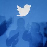The shadows of people holding mobile phones are cast onto a backdrop projected with the Twitter logo in this illustration picture taken in W The shadows of people holding mobile phones are cast onto a backdrop projected with the Twitter logo in this illustration picture taken in W