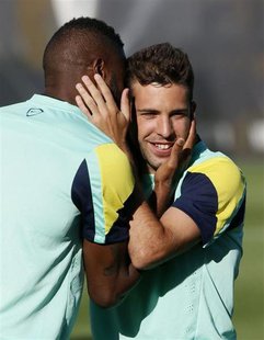 Barcelona's Alex Song (L) hugs his teammate Jordi Alba during a training session at the Ciutat Esportiva Joan Gamper in Sant Joan Despi near Barcelona's Alex Song (L) hugs his teammate Jordi Alba during a training session at the Ciutat Esportiva Joan Gamper in Sant Joan Despi near
